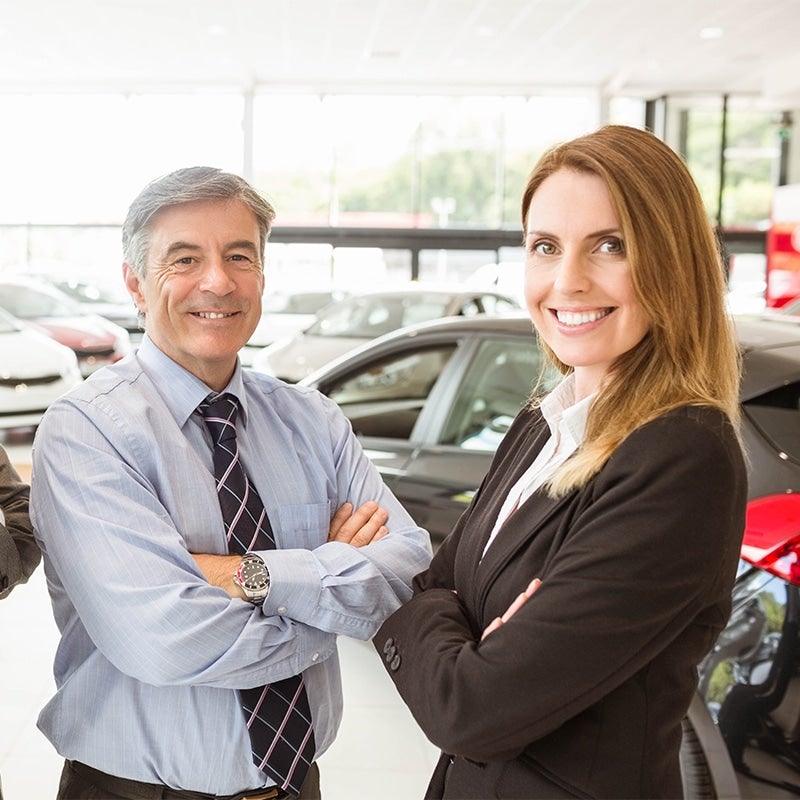 sales people with smiling with their arms folded img